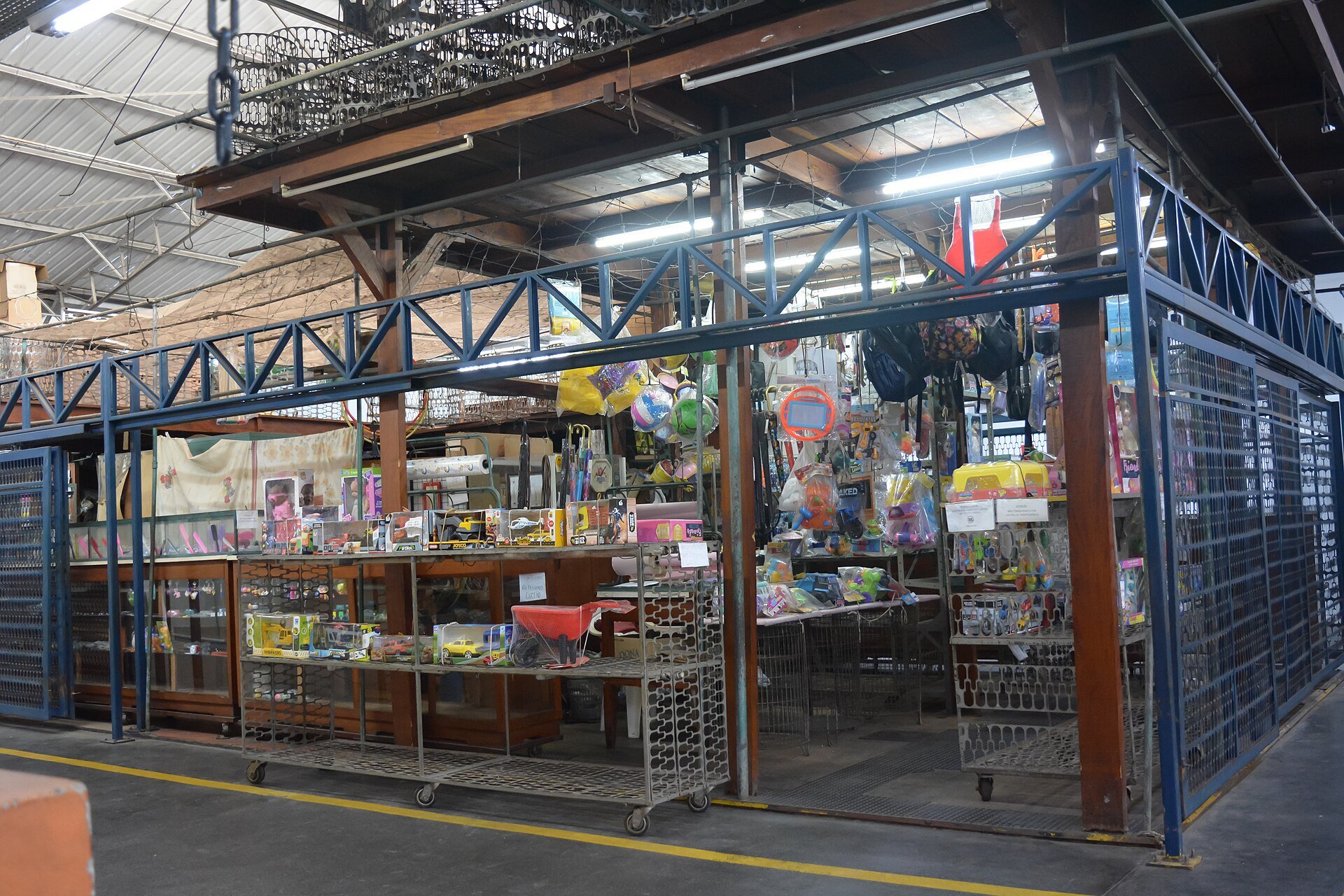 Loja tradicional de brinquedos com prateleiras cheias em mercado municipal